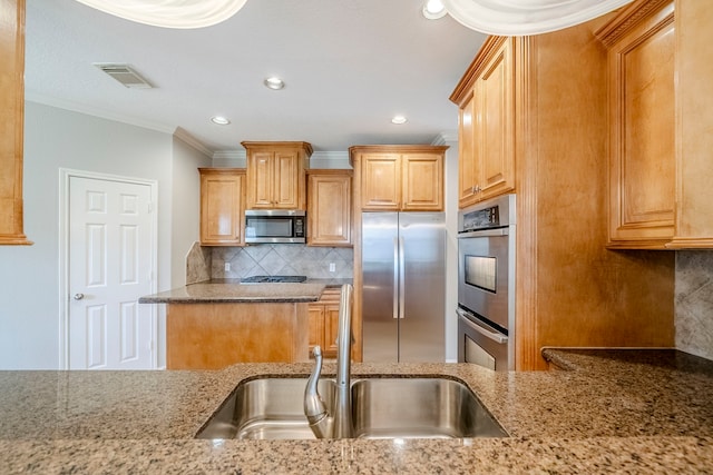 kitchen with stainless steel appliances, a sink, visible vents, light stone countertops, and crown molding