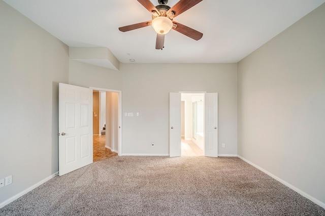 unfurnished bedroom with light carpet, baseboards, and a ceiling fan