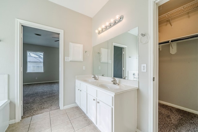 full bath with tile patterned flooring, a sink, and a spacious closet