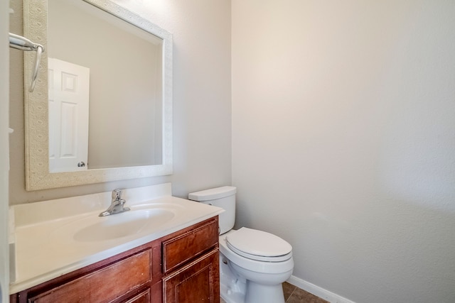 bathroom featuring toilet, tile patterned flooring, and vanity