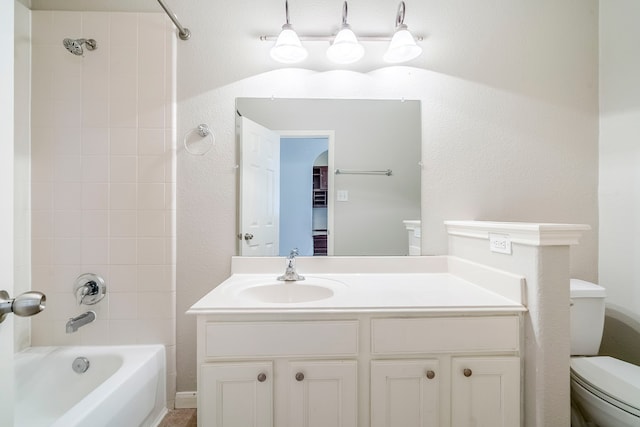 full bath with toilet, a textured wall, vanity, and bathing tub / shower combination