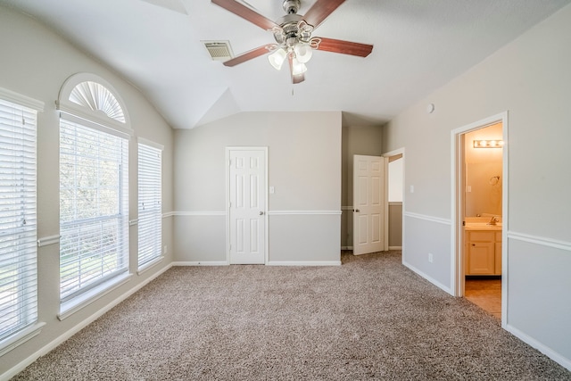 unfurnished bedroom featuring light carpet, multiple windows, and visible vents