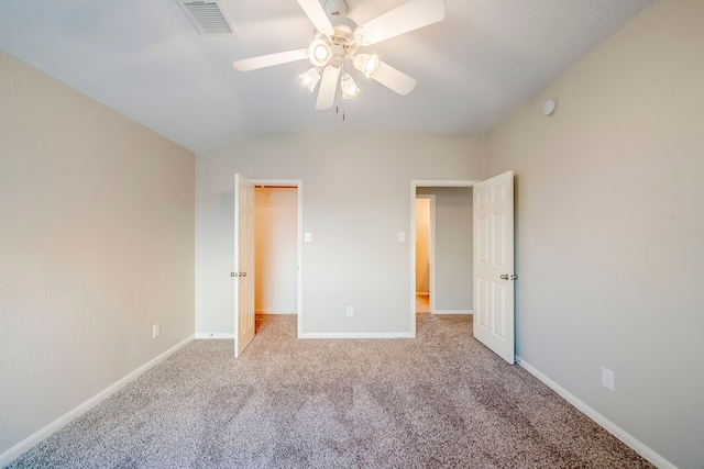 unfurnished bedroom featuring baseboards, visible vents, a ceiling fan, lofted ceiling, and carpet flooring