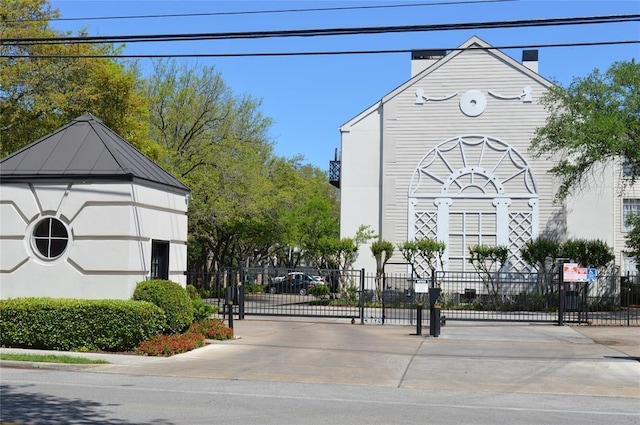 view of road with a gated entry and a gate