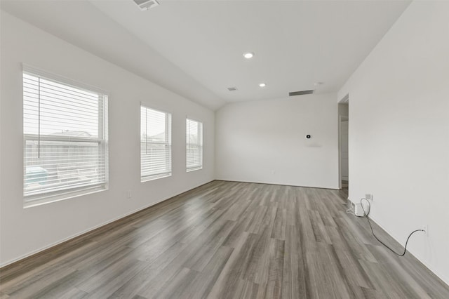 empty room with recessed lighting, visible vents, and wood finished floors