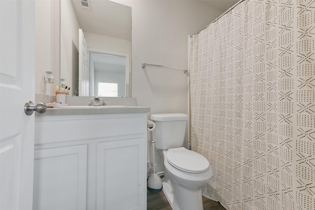 full bathroom featuring visible vents, toilet, vanity, wood finished floors, and a shower with curtain