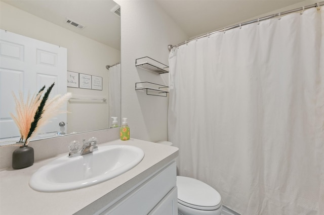 full bathroom with visible vents, vanity, and toilet