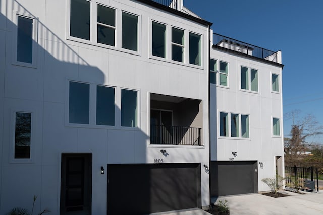 view of building exterior with a garage and concrete driveway