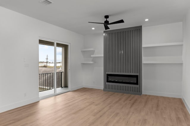 unfurnished living room with baseboards, ceiling fan, visible vents, and wood finished floors