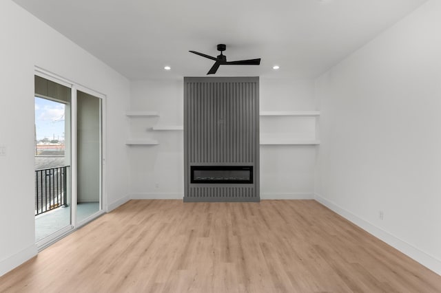 unfurnished living room featuring baseboards, wood finished floors, and recessed lighting