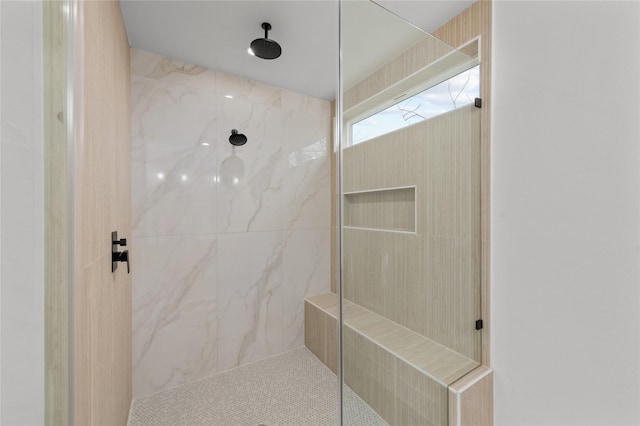 bathroom with a marble finish shower