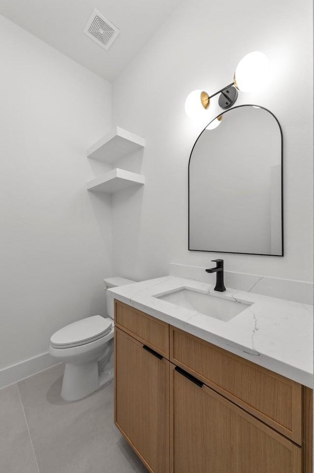 half bathroom featuring baseboards, visible vents, toilet, tile patterned floors, and vanity