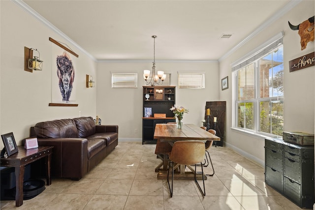 dining space featuring baseboards, ornamental molding, visible vents, and an inviting chandelier