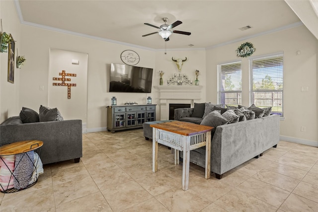 living area with ceiling fan, a fireplace, visible vents, baseboards, and ornamental molding