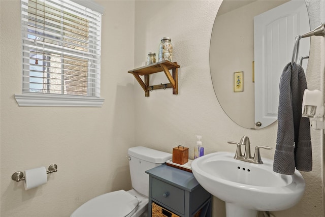 half bathroom with a sink and toilet