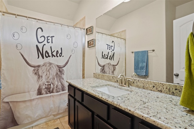 full bathroom featuring a shower with shower curtain, tile patterned floors, and vanity