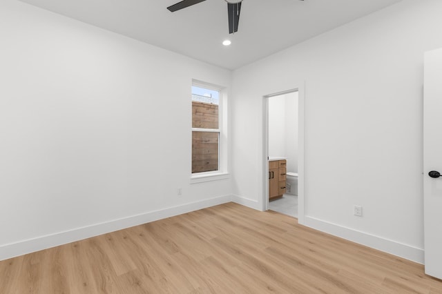 unfurnished room featuring ceiling fan, light wood finished floors, and baseboards