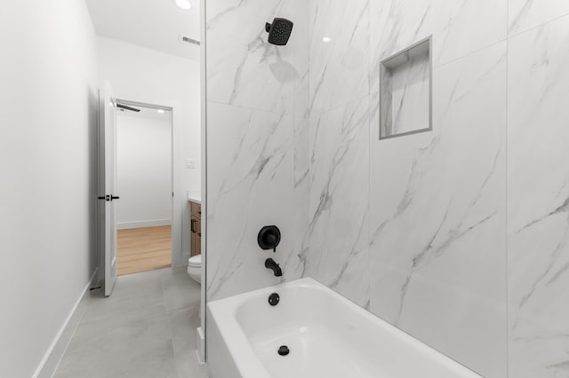 bathroom featuring toilet, shower / tub combination, baseboards, and vanity