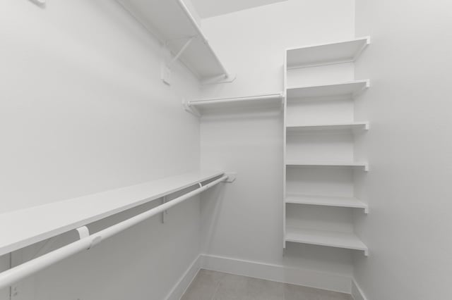 walk in closet featuring tile patterned flooring