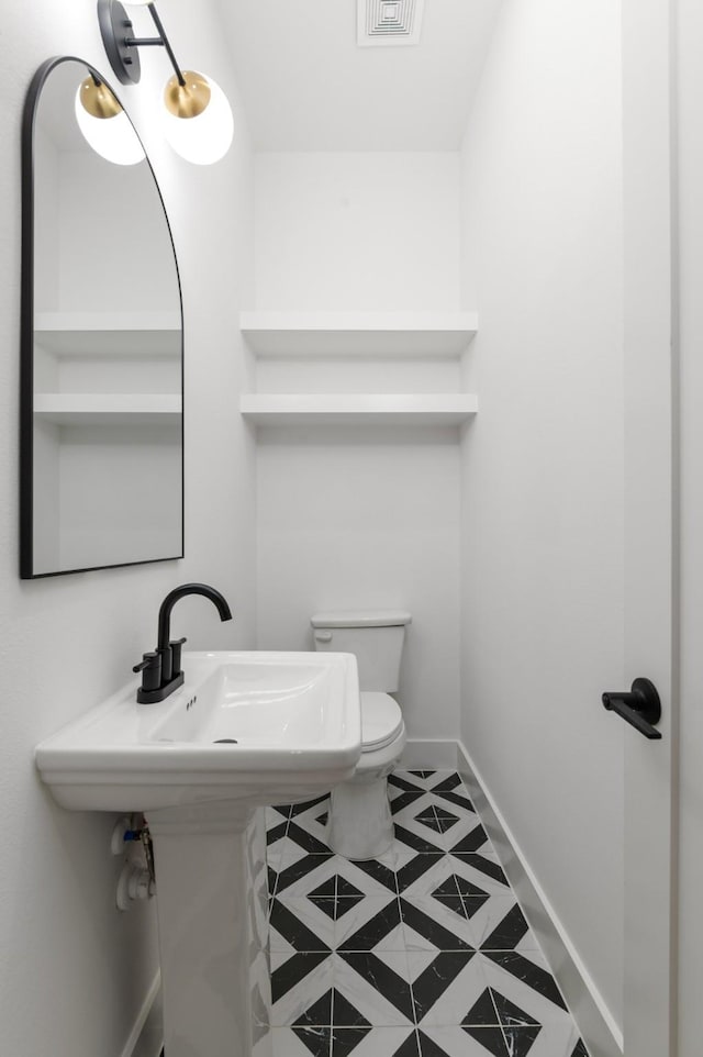 bathroom featuring visible vents, tile patterned flooring, toilet, and baseboards