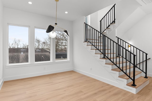 unfurnished dining area with stairs, baseboards, wood finished floors, and recessed lighting