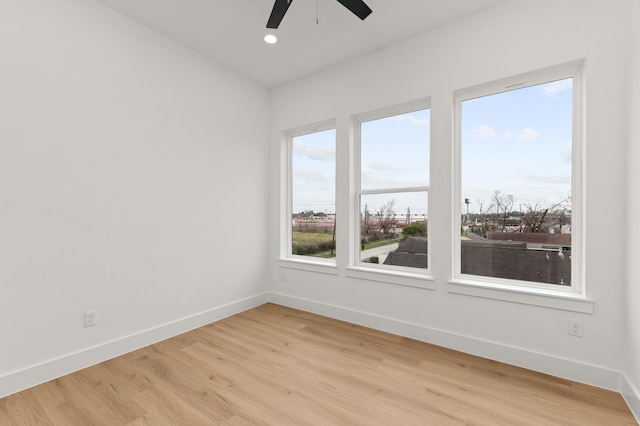 spare room with recessed lighting, ceiling fan, light wood-style flooring, and baseboards