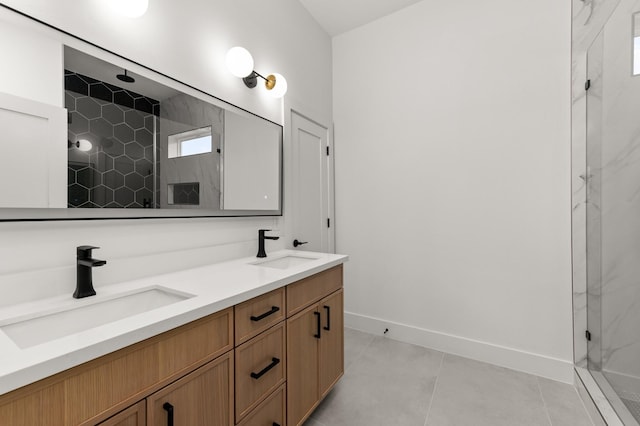 bathroom featuring double vanity, a marble finish shower, a sink, and tile patterned floors