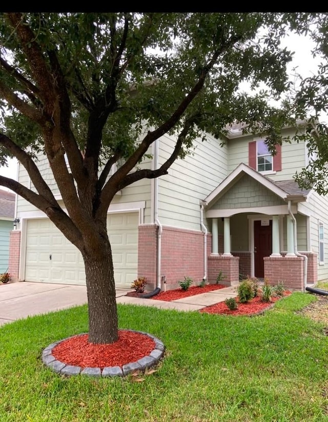 view of front of house with brick siding, driveway, and a front lawn