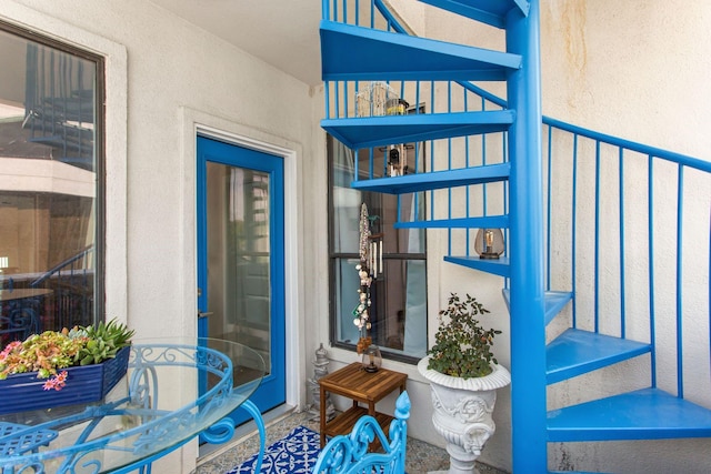 doorway to property featuring stucco siding