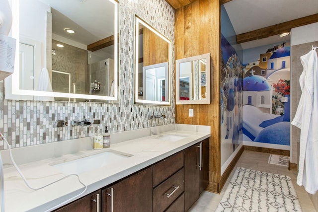 bathroom featuring double vanity, a stall shower, a sink, decorative backsplash, and connected bathroom