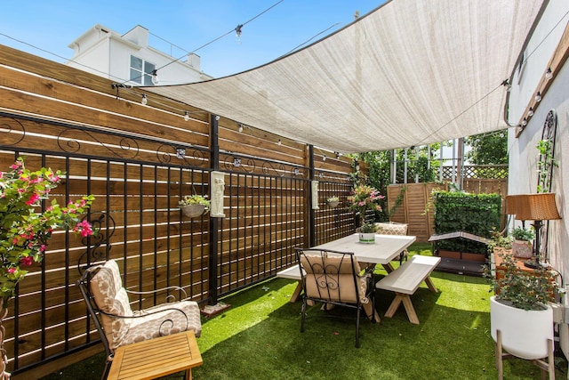 view of patio / terrace featuring fence