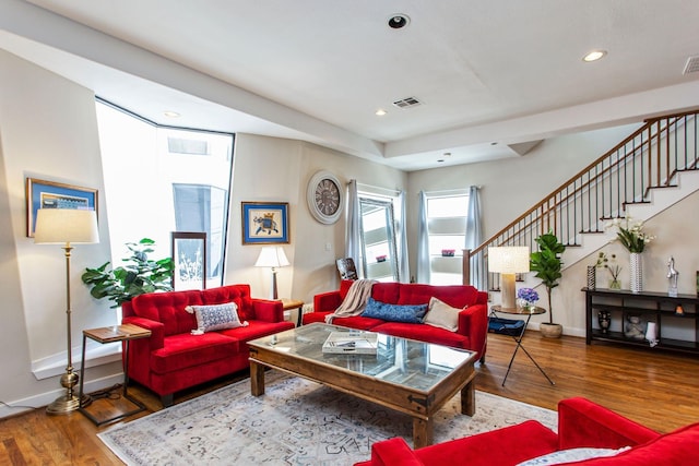 living area with visible vents, wood finished floors, recessed lighting, baseboards, and stairs