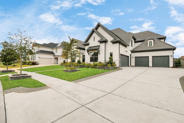 view of front of property with a garage, a front lawn, concrete driveway, and stucco siding