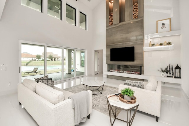 living room with baseboards and a high ceiling