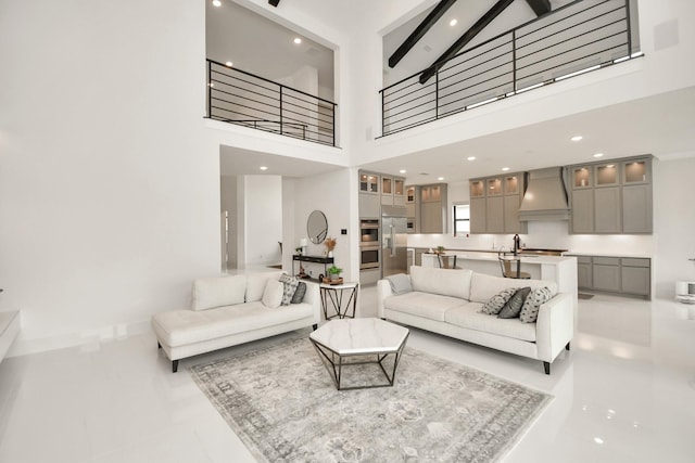 living room with a towering ceiling and recessed lighting