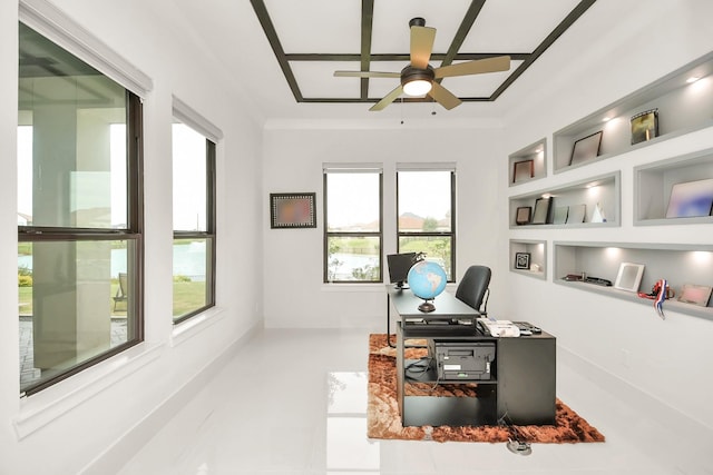 office space with built in shelves, ornamental molding, and a ceiling fan