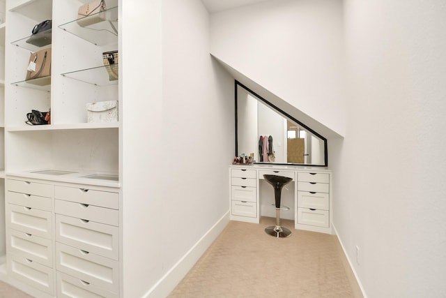 unfurnished office featuring baseboards and light colored carpet