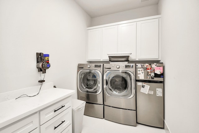 laundry room with cabinet space and washer and dryer