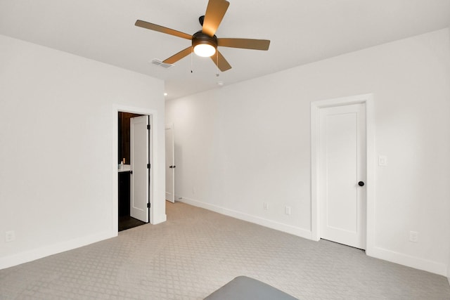 carpeted empty room with baseboards, visible vents, and ceiling fan