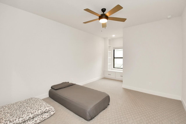 bedroom featuring a ceiling fan, carpet, and baseboards