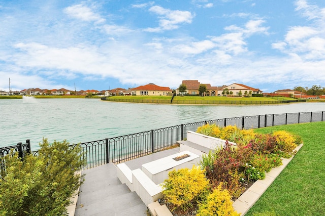 property view of water featuring a residential view and fence