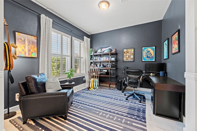 office area featuring a textured wall and baseboards