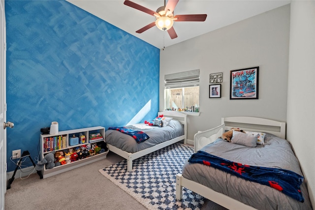 carpeted bedroom with ceiling fan and baseboards