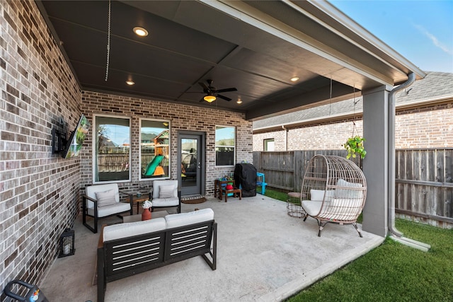 view of patio / terrace with grilling area, fence, outdoor lounge area, and a ceiling fan