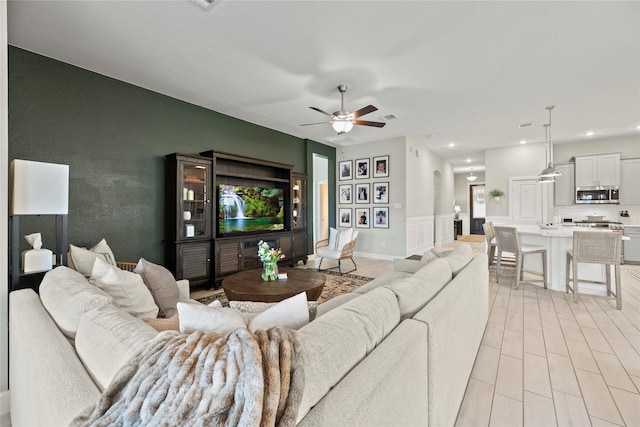 living area featuring ceiling fan and recessed lighting