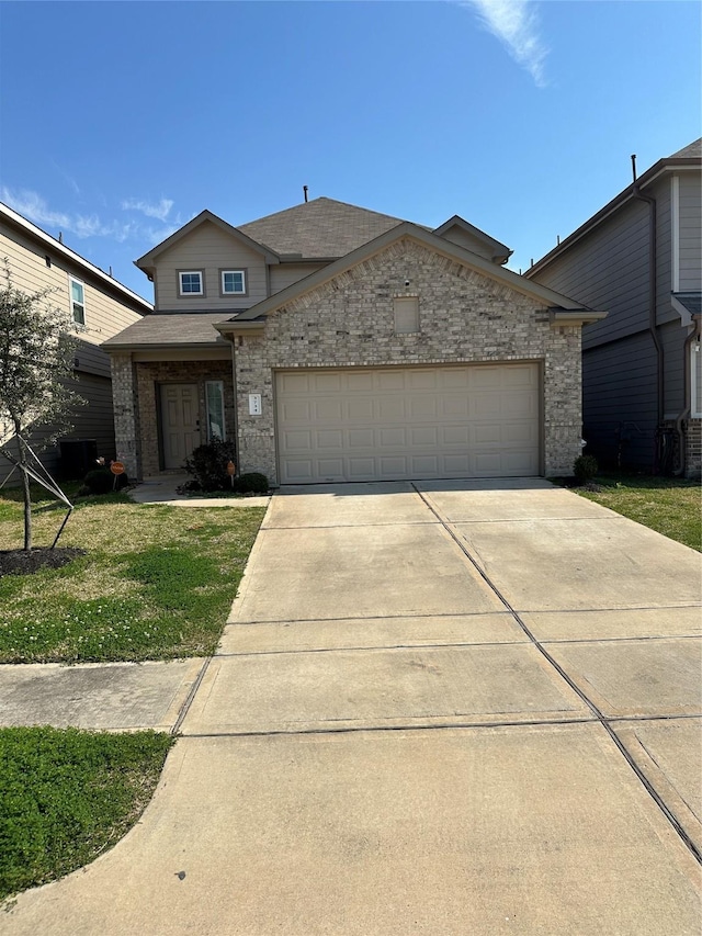 view of front facade with a front yard, driveway, a shingled roof, a garage, and brick siding