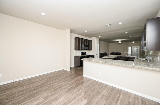3734 Giorgio Pastel Pl, Katy, TX 77493 - kitchen featuring a peninsula, light wood-style floors, baseboards, and ceiling fan