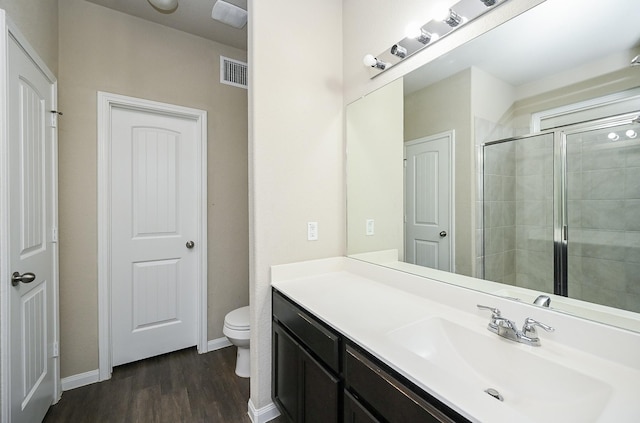3734 Giorgio Pastel Pl, Katy, TX 77493 - bathroom featuring vanity, wood finished floors, visible vents, tiled shower, and toilet