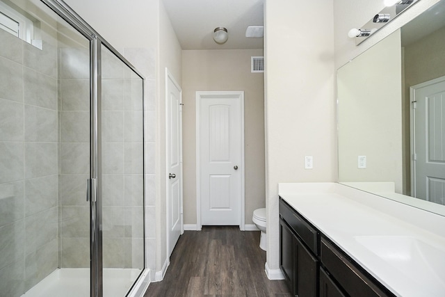 3734 Giorgio Pastel Pl, Katy, TX 77493 - bathroom featuring visible vents, a shower stall, toilet, wood finished floors, and vanity