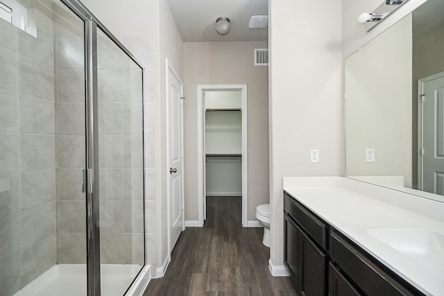 3734 Giorgio Pastel Pl, Katy, TX 77493 - bathroom with visible vents, toilet, a stall shower, wood finished floors, and vanity